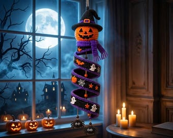 May include: A hanging crochet decoration featuring an orange jack-o'-lantern head wearing a black witch hat and a purple scarf. Below the head is a purple and black spiral ribbon adorned with small white ghosts, orange stars, and spider motifs.