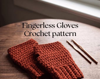 May include: A pair of rust-colored crocheted fingerless gloves with a ribbed cuff and a thumb opening, accompanied by two metal crochet hooks. The text reads: Fingerless Gloves Crochet pattern. Instant PDF Download.