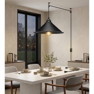 May include: A black, cone-shaped pendant light hangs above a dining table. The light fixture is suspended from a black arm attached to the ceiling. The dining table is set with plates, bowls, and utensils.