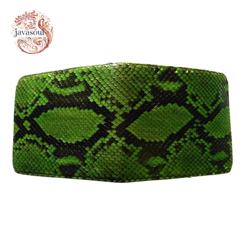 May include: A green and black snakeskin-patterned wallet. The wallet is rectangular and has a textured surface. The logo "javasoul" is in the upper left corner. The wallet is made of a material that resembles snakeskin.