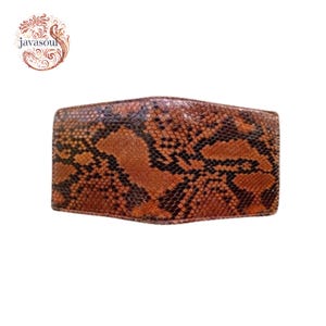May include: A brown and black snakeskin wallet. The wallet has a bi-fold design and is made of genuine snakeskin. The wallet is a rectangle shape and has a natural pattern. The wallet is a neutral colour and can be used by anyone.