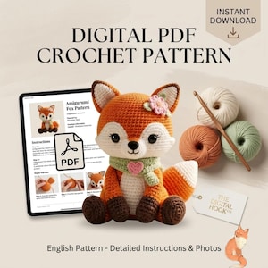 May include: A digital PDF crochet pattern for an amigurumi fox. The image shows a tablet displaying the pattern, a finished crocheted fox toy with a green scarf and pink heart, three balls of yarn, a wooden crochet hook, and a brand tag.