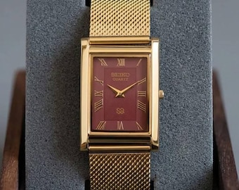 Vintage Seiko tankhorloge kastanjebruine Romeinse wijzerplaat, goudkleurige kast jurkstijl