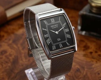 Zeldzaam vintage Seiko quartzhorloge heren | Tankhorloge met zwarte wijzerplaat | Zilveren mesh-armband | Gerenoveerd