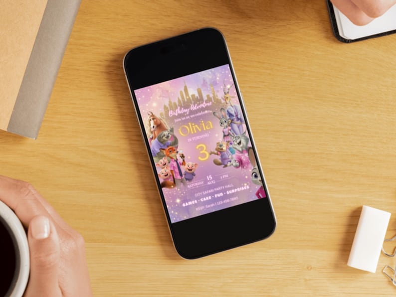 May include: A smartphone displaying a digital birthday invitation with a purple and gold Zootopia-themed graphic. The invitation features cartoon animal characters, the name Olivia, the number 3, and event details including date, time, and location.