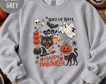 May include: A sport grey crewneck sweatshirt featuring a graphic print with the text Trick or Treat, Boo, and Happy Halloween. The design includes illustrations of skulls, a bat, a ghost, a spider web, a black cat, pumpkins, and candy.