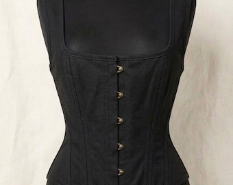 May include: A black sleeveless corset top featuring a square neckline and a front closure with five metallic brass-toned buttons. The garment is constructed with vertical seams and a structured bodice, displayed on a black mannequin torso.