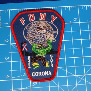 May include: A white ceramic mug with a black handle and the text "But First, Coffee" in a black, handwritten-style font. The mug is on a white surface.