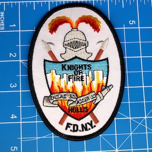 May include: A white ceramic mug with a black handle and the text "But First, Coffee" in a bold, black font. The mug is set against a blurred background, highlighting its simple design.