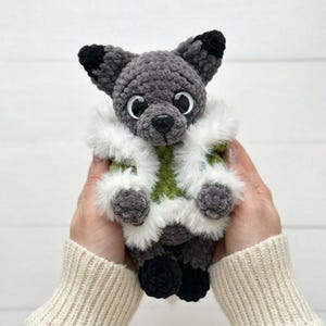 May include: A set of three ceramic mugs with a speckled, matte finish. The mugs are in shades of cream, light gray, and dark gray. Each mug has a simple, minimalist design, perfect for coffee or tea.