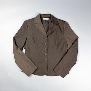 May include: A brown blazer with a notched collar and five buttons. The tailored jacket has long sleeves and a fitted silhouette. The fabric appears to have a subtle texture. The blazer is a classic piece of apparel.
