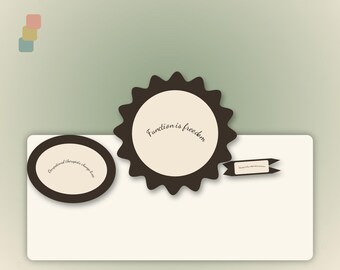 May include: A set of three cream-coloured paper labels with dark brown borders. One is oval with the text 'Occupational therapists change lives', one is a scalloped circle with 'Function is freedom', and one is a small rectangular banner.