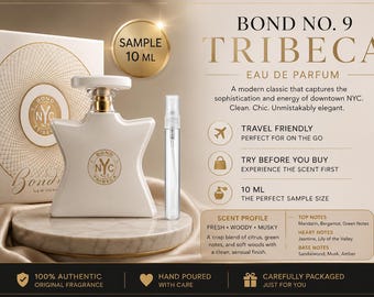 May include: A Bond No. 9 Tribeca eau de parfum bottle in a star-shaped white glass design with a gold logo, accompanied by a 10 ml sample spray vial. The product is displayed with its branded box, featuring text detailing scent notes and travel size.