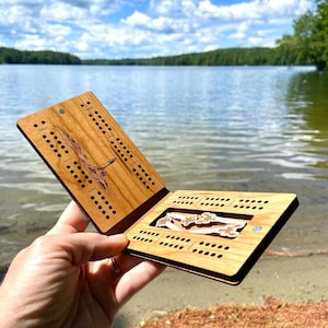 Travel cribbage board opened and lake view in background