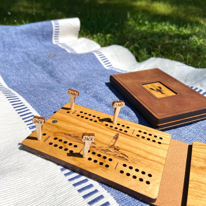 Travel Cribbage board on beach blanket. Custom name cribbage pegs