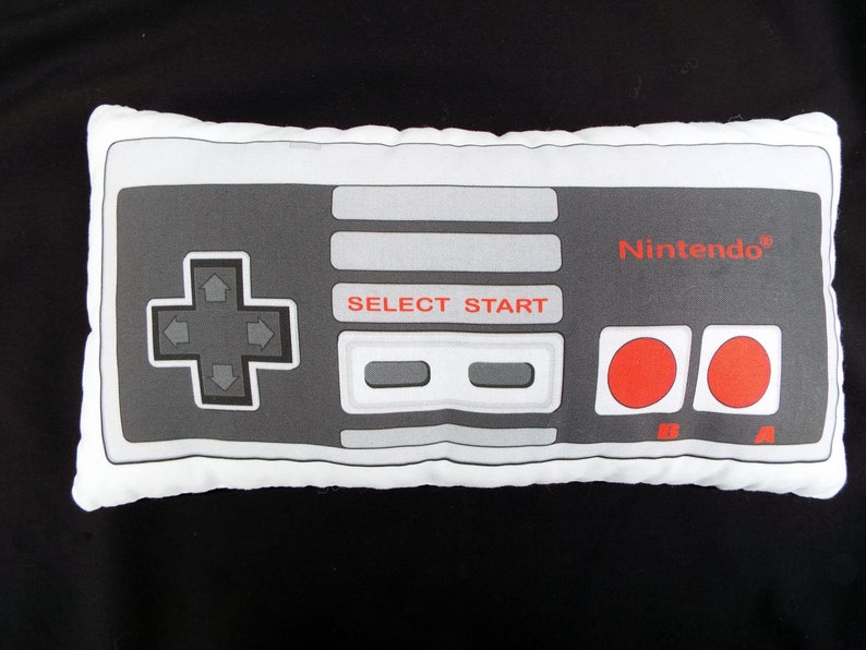 Nintendo Classic game controller plush in cotton with a fleece backing. Approximately 9" x 13" and printed in exact detail. Great gift for gamers of all ages. Hypoallergenic stuffing.