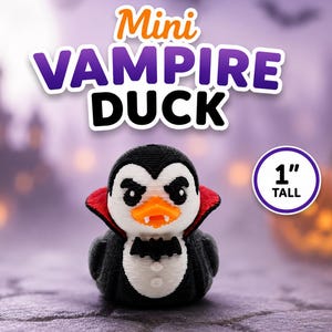 May include: A small black and white duck figurine dressed as a vampire with a red-lined cape, a black bat bowtie, and white fangs. The text "Mini VAMPIRE DUCK" appears above the figure, and a circular badge indicates it is 1 inch tall.