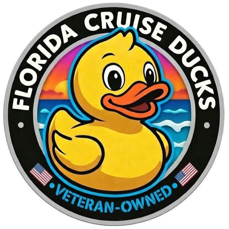 May include: A circular sticker featuring a yellow rubber duck in the center against a sunset ocean background. The black border contains the white text FLORIDA CRUISE DUCKS and VETERAN-OWNED, with two small American flag icons on the bottom sides.