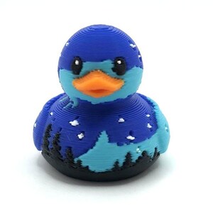 Mini Northern Lights Duck with aurora borealis design, 1 inch tall 3D printed cruise duck, blue and teal Alaska-inspired mini duck with snowy winter background, exclusive handmade duck collectible for cruise hiding and duck exchanges. Perfect for Alaska cruises and alaska gifts.  3D printed with PLA plastic.