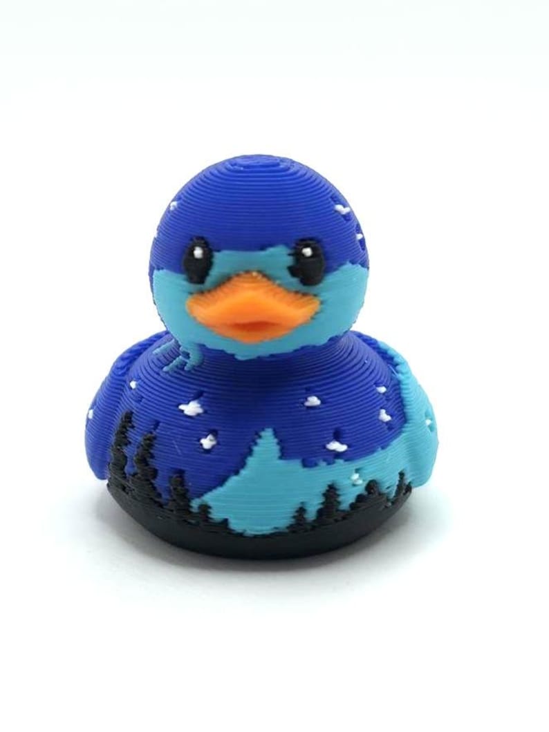 Mini Northern Lights Duck with aurora borealis design, 1 inch tall 3D printed cruise duck, blue and teal Alaska-inspired mini duck with snowy winter background, exclusive handmade duck collectible for cruise hiding and duck exchanges. Perfect for Alaska cruises and alaska gifts.  3D printed with PLA plastic.