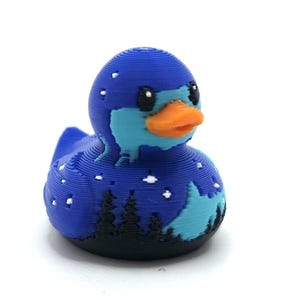 Mini Northern Lights Duck with aurora borealis design, 1 inch tall 3D printed cruise duck, blue and teal Alaska-inspired mini duck with snowy winter background, exclusive handmade duck collectible for cruise hiding and duck exchanges. Perfect for Alaska cruises and alaska gifts.  3D printed with PLA plastic.