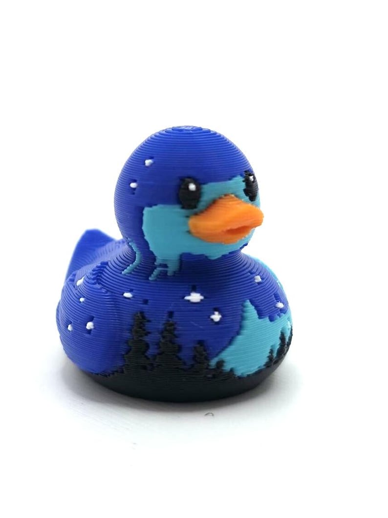 Mini Northern Lights Duck with aurora borealis design, 1 inch tall 3D printed cruise duck, blue and teal Alaska-inspired mini duck with snowy winter background, exclusive handmade duck collectible for cruise hiding and duck exchanges. Perfect for Alaska cruises and alaska gifts.  3D printed with PLA plastic.