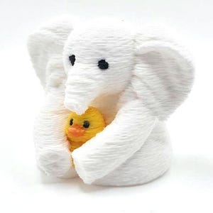 Mini towel animal elephant holding a yellow duck, 3D printed collectible by Florida Cruise Ducks. White elephant design with textured towel-like appearance, approximately 1 inch tall. Shown from multiple angles including front, side, back, hand-held size comparison, and marker comparison. Perfect for cruise duck hiding, cruise gifts, duck exchanges, party favors, and miniature collectibles. Exclusive Florida Cruise Ducks design.