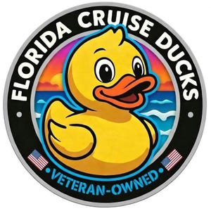 May include: A circular sticker featuring a yellow rubber duck with an orange beak centered against a sunset ocean background. The black border displays the white text FLORIDA CRUISE DUCKS and VETERAN-OWNED, with two small American flag icons.