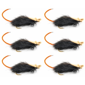 May include: Six identical fishing lures shaped like mice, each featuring a black fur body, tan foam ears, and a long orange tail. A gold-colored metal hook is attached to the underside of each lure, designed for fly fishing applications.