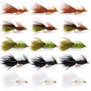 May include: A collection of fifteen fishing flies arranged in five rows of three. The flies feature gold-colored beads at the head and are tied with feathers in brown, olive green, dark green, black, and white colors on metal hooks.