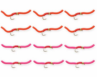 May include: A set of twelve fishing flies arranged in a grid. The top two rows feature six orange worm-like lures with gold beads and silver hooks. The bottom two rows feature six pink worm-like lures with gold beads and silver hooks.
