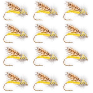 May include: Twelve fishing flies, each with a yellow body and a wing of brown and grey feathers. The flies are arranged in a grid. The hooks are curved. The background is white.