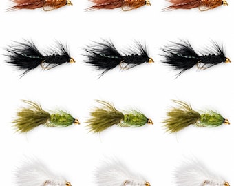 May include: A collection of twelve fishing flies arranged in four rows of three. The flies feature brown, black, olive green, and white feathered bodies with gold-colored metal beads at the head and curved metal hooks underneath each lure.