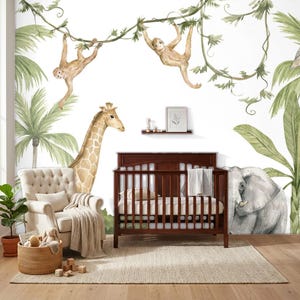 May include: A wall mural featuring watercolor illustrations of two monkeys hanging from vines, a giraffe, and an elephant amidst palm leaves. The scene includes a dark wood crib, a beige tufted armchair with a throw blanket, and a woven basket.