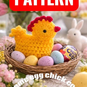 May include: A yellow crochet chick with red detailing rests in a wicker basket with speckled Easter eggs and a Creme Egg. The word "PATTERN" is in a red box. Text reads "Creme egg chick cosy".