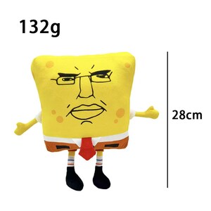 May include: A yellow plush toy resembling a cartoon character with a stern expression, wearing glasses, a red tie, and a white shirt. The toy is approximately 11 inches tall and weighs 132 grams.