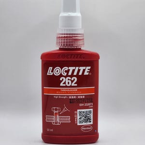 May include: A red Loctite 262 Threadlocker bottle with a white cap. The label includes the Loctite logo, product information, and a QR code. The bottle contains 50 ml of threadlocker.