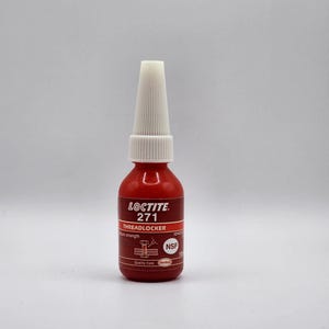 May include: A red Loctite 271 Threadlocker bottle with a white nozzle. The bottle has black and white text, including the product name and NSF certification. The product is designed for high strength applications.