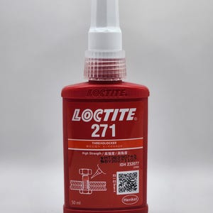 May include: A red Loctite 271 Threadlocker bottle with a white nozzle. The bottle has white text and graphics, including "High Strength" and a QR code. It contains 50 ml of product.