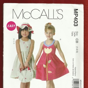May include: McCall's MP403 sewing pattern for a girl's dress in sizes 1-2-3. The pattern includes two dress styles, one with a pink and white polka dot print and the other with a green and white striped print. The pattern also includes a hat and a bag.