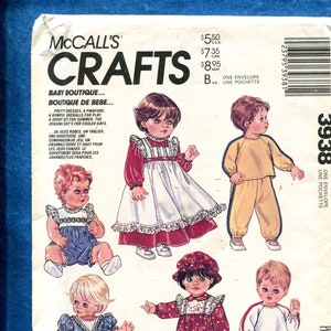 May include: A sewing pattern for baby clothes. The pattern includes a pinafore dress, a romper, a short set, and a jogging suit. The pattern is from McCall's Crafts and is called "Baby Boutique".