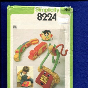 May include: Simplicity 8224 sewing pattern for stuffed toys. The pattern includes instructions for a telephone, train, and other whimsical designs. The cover is green with the pattern number and a photo of the finished toys.