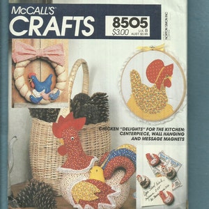 May include: A McCall's Crafts pattern book featuring chicken-themed craft projects. The cover displays a wreath, a rooster, and a hen in an embroidery hoop. The projects include a centerpiece, wall hanging, and message magnets.