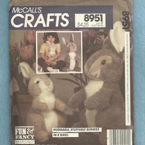 May include: McCall's Crafts pattern for huggable, stuffable bunnies in two sizes. The pattern cover features a photo of a child holding a bunny and two finished bunnies. The pattern number is 8951.