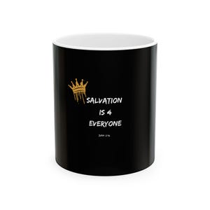 May include: Black ceramic mug with a white interior. The mug features the text "SALVATION IS 4 EVERYONE" in white, with a gold crown graphic. The text "John 3:16" is below the text. The mug is a standard size.