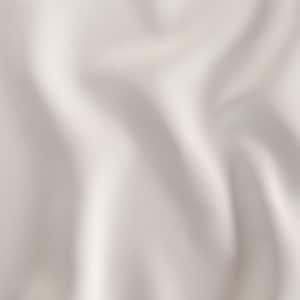 May include: A close-up shot of a cream-colored fabric with soft, flowing folds. The fabric has a subtle texture and a matte finish, creating a sense of depth and movement. The lighting highlights the curves and shadows of the material.