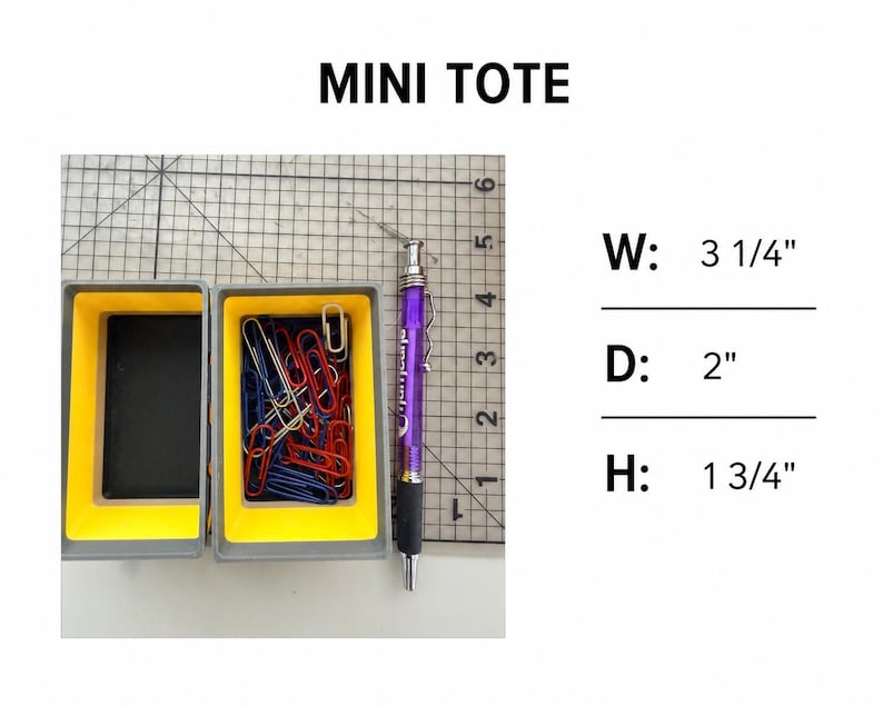 May include: A grey and yellow mini tote container filled with red, blue, and silver paper clips, positioned next to a purple mechanical pencil on a grid mat. Text reads MINI TOTE with dimensions W: 3 1/4", D: 2", and H: 1 3/4".