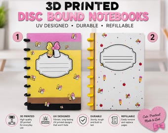 May include: Two 3D printed disc bound notebooks with UV designs. Notebook 1 is yellow, pink, and black with pencil motifs and a central label. Notebook 2 is white with small pencil and apple icons, yellow discs, and a central label for writing text.