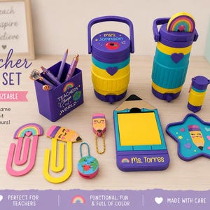 May include: A teacher desk set featuring a purple pencil holder with the text Teachers Change the World, two water jugs with handles, a pencil-shaped sticky note holder labeled Ms. Torres, a star-shaped tray, and various colorful stationery items.