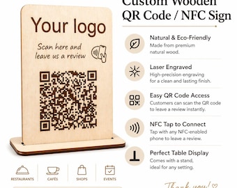 May include: A rectangular light-colored wooden sign with a dark brown laser-engraved QR code, the text Your logo, Scan here and leave us a review, and an NFC icon. The sign is mounted on a matching wooden base and includes descriptive text.
